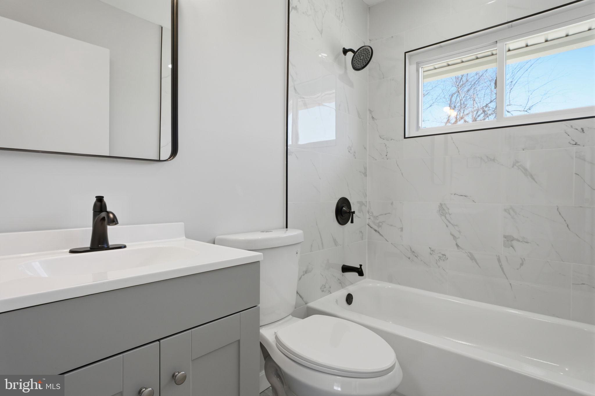 10 MacIntosh Road Levittown, PA 19056 - Photo 22 of 41 a bathroom with a sink a toilet and a bathtub