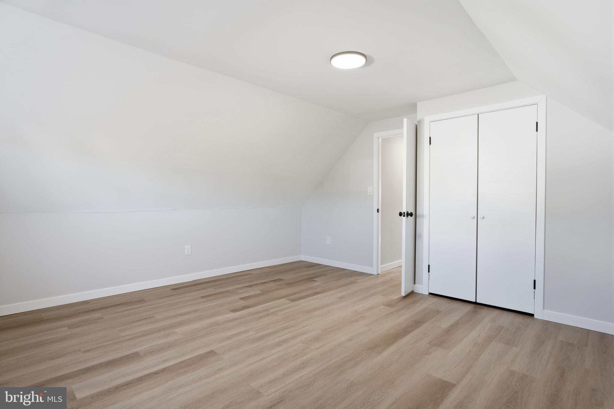 10 MacIntosh Road Levittown, PA 19056 - Photo 28 of 41 a view of an empty room with wooden floor