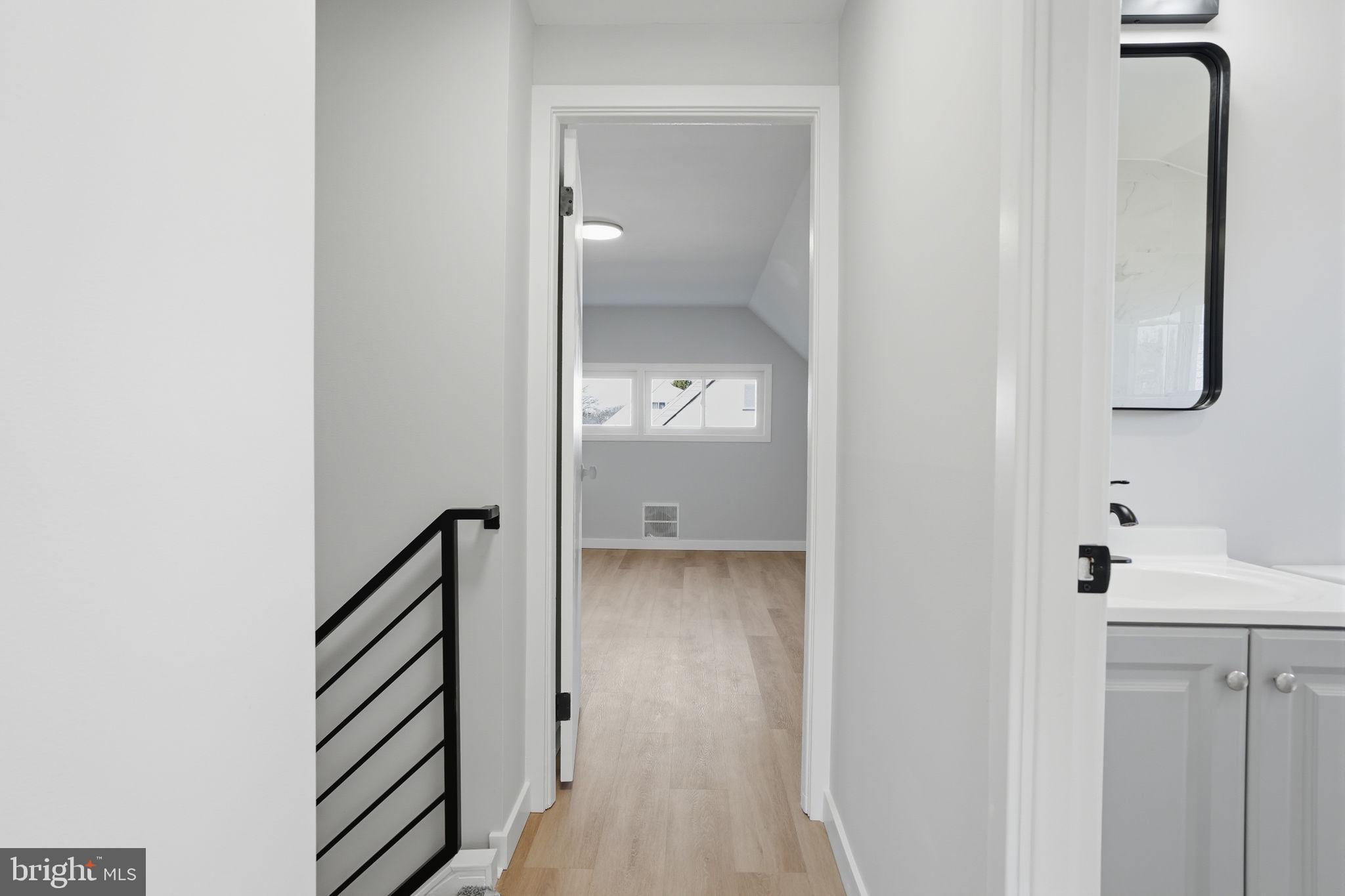 10 MacIntosh Road Levittown, PA 19056 - Photo 31 of 41 a view of a bathroom from a corridor