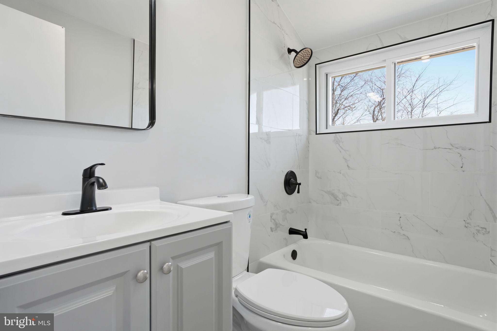 10 MacIntosh Road Levittown, PA 19056 - Photo 32 of 41 a bathroom with a sink a toilet and shower