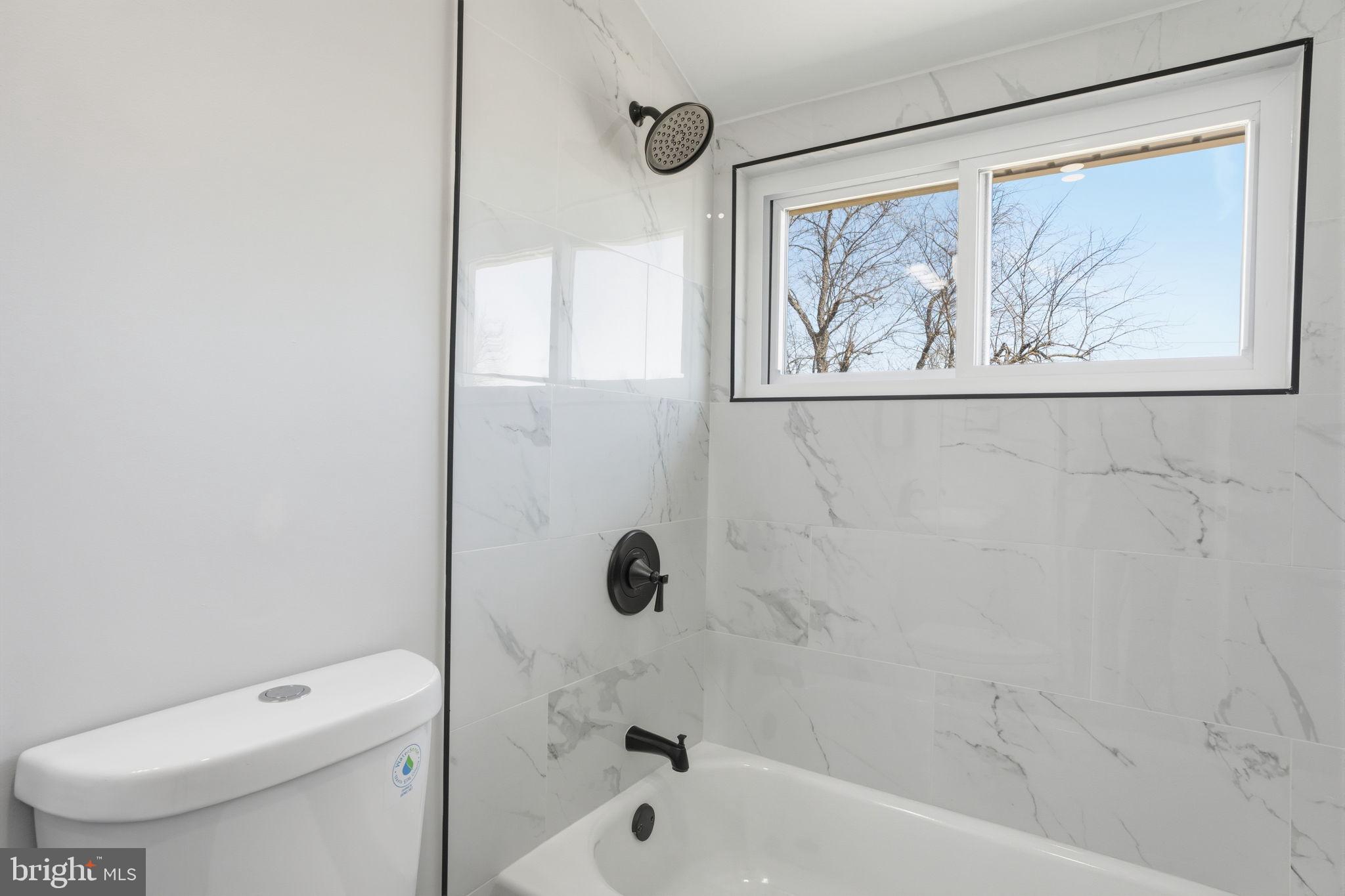 10 MacIntosh Road Levittown, PA 19056 - Photo 33 of 41 a bathroom with a toilet a sink and tub