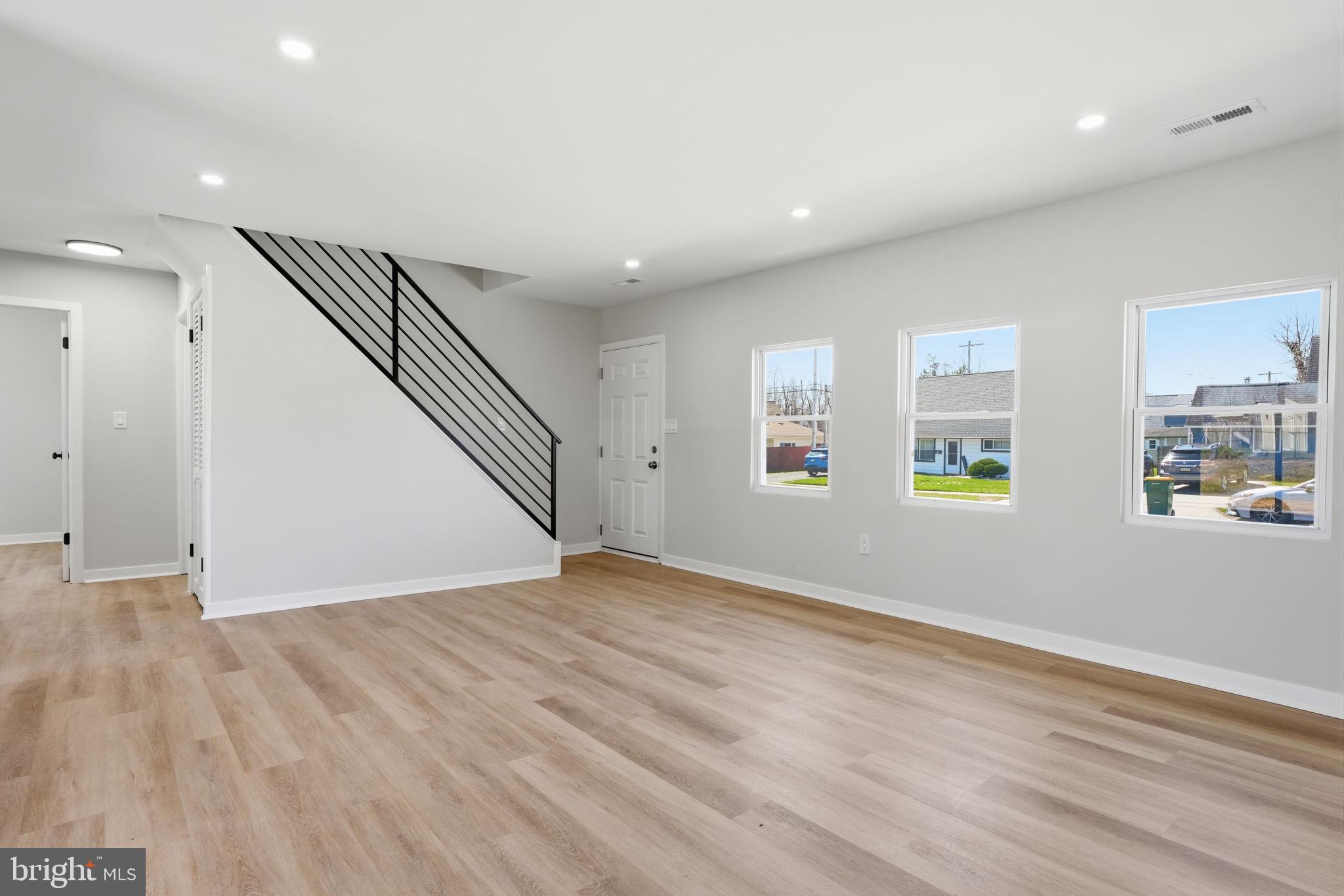10 MacIntosh Road Levittown, PA 19056 - Photo 7 of 41 an empty room with wooden floor and windows