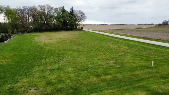 a view of a field with an ocean view
