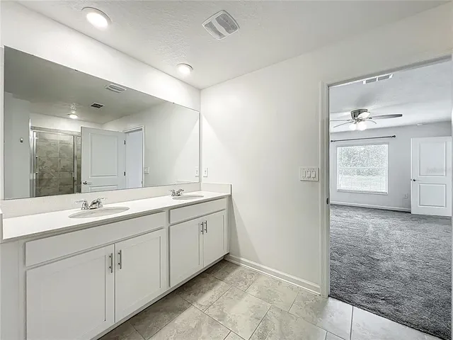a bathroom with a granite countertop sink mirror and