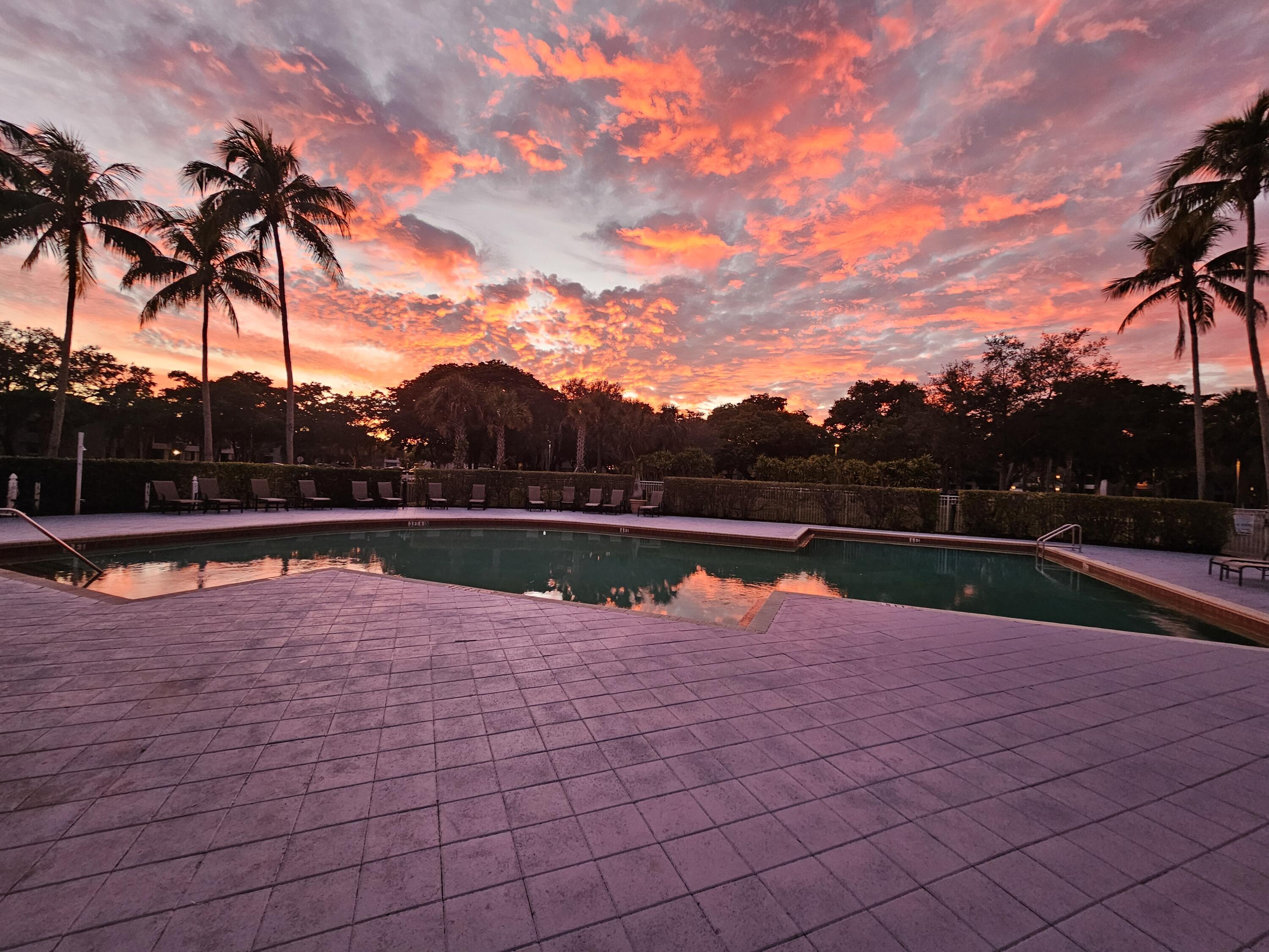 641 Lyons Road, Unit 11203 Coconut Creek, FL 33063 - Photo 13 of 27 Coco Parc Pool Twilight