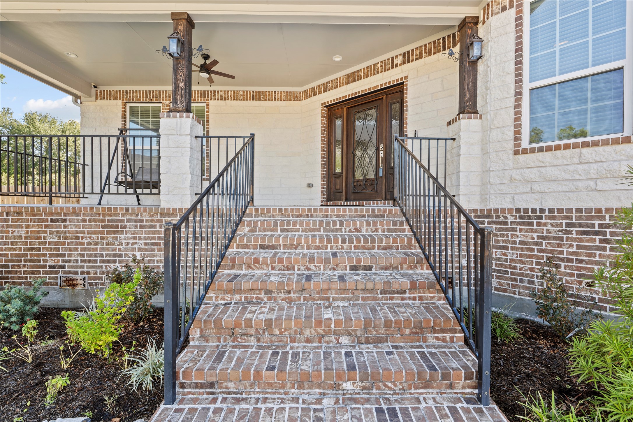 6207 Graff Net Court Spring, TX 77379 - Photo 11 of 49 Spacious front porch with a fan and elegant stairs creating a stunning entrance. Imagine having your morning coffee on this porch!