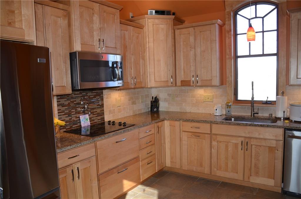 114 Walker Road Prospect, PA 16052 - Photo 8 of 25 The kitchen has maple cabinets, granite counter tops, glass and stone backsplash and a pot filler over the stove.