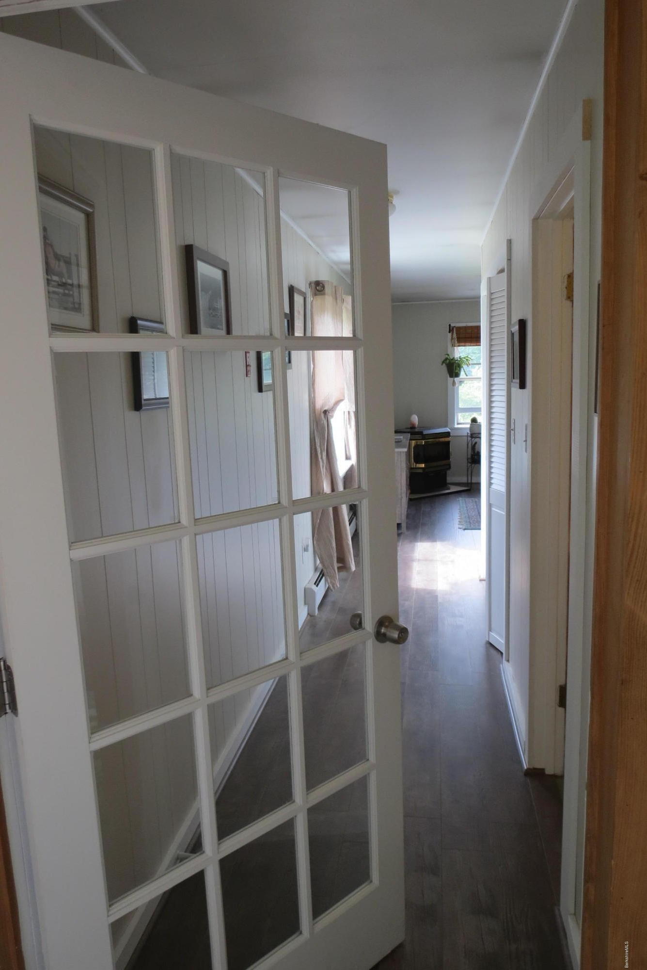 1304 Main Road Savoy, MA 01256 - Photo 13 of 28 a view of a hallway with wooden floor fireplace and living room