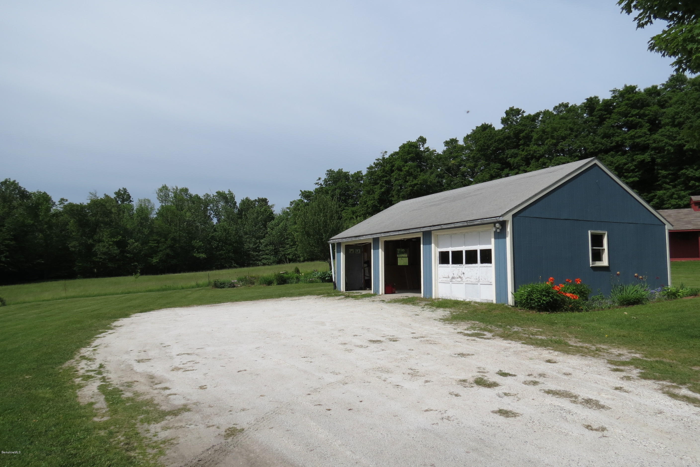 1304 Main Road Savoy, MA 01256 - Photo 19 of 28 a house with trees in the background