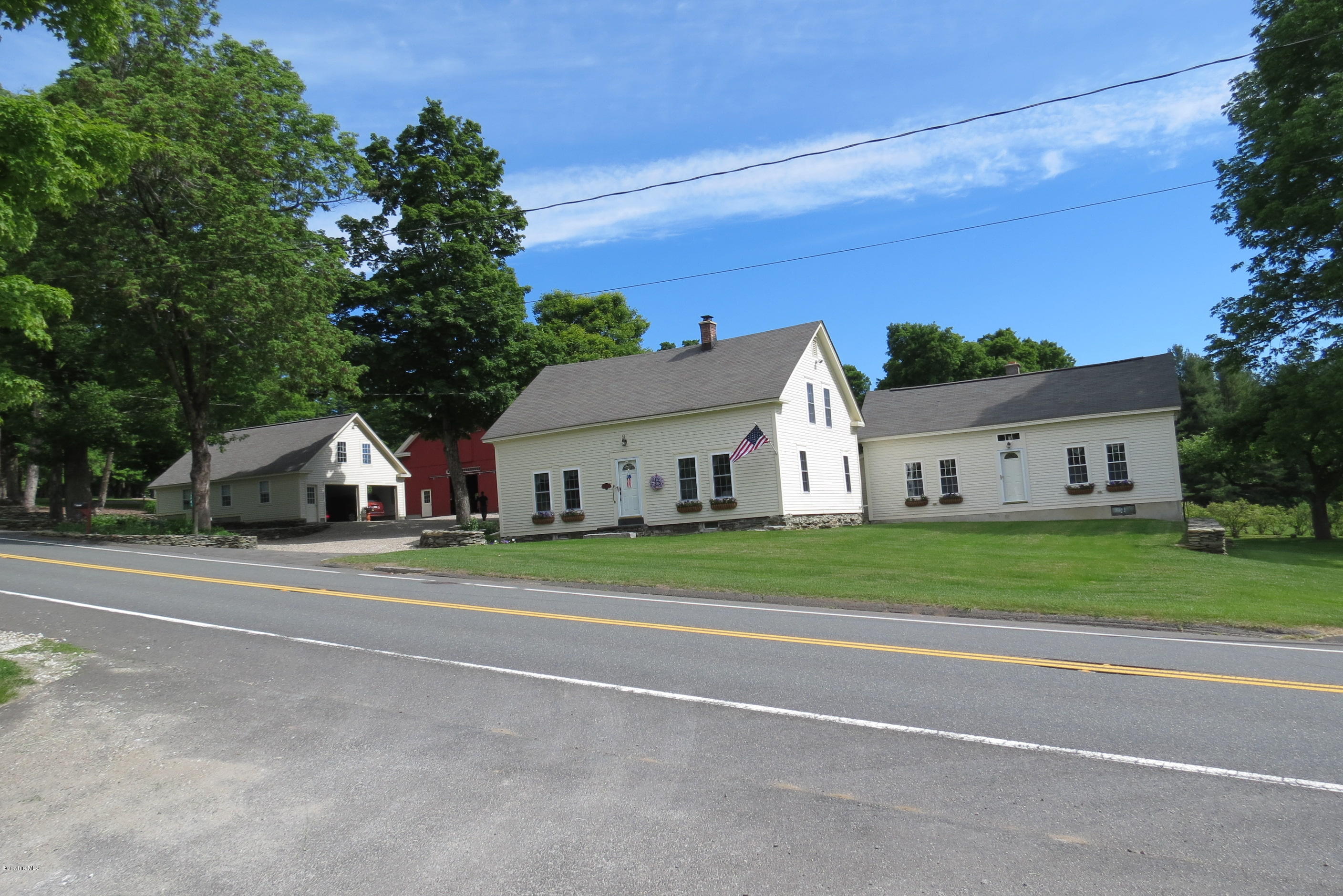 1304 Main Road Savoy, MA 01256 - Photo 25 of 28 a front view of a house with a yard and garage