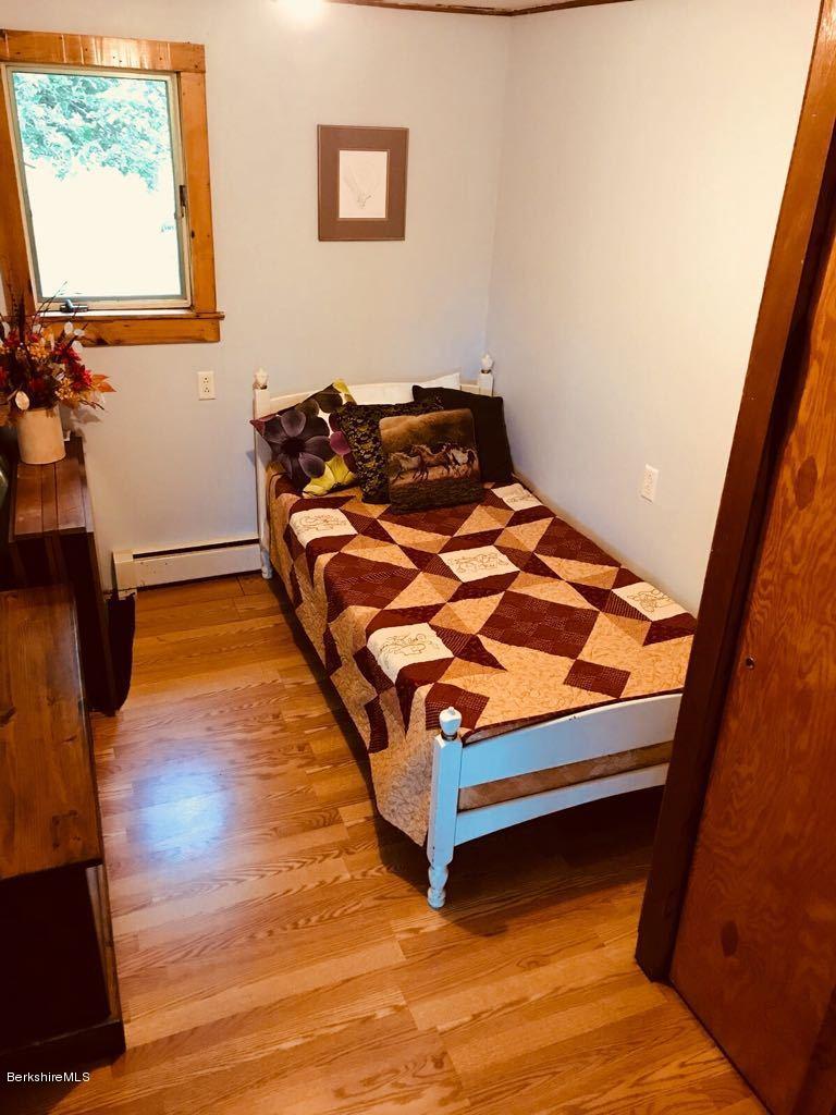 1304 Main Road Savoy, MA 01256 - Photo 4 of 28 a bedroom with a bed and wooden floor