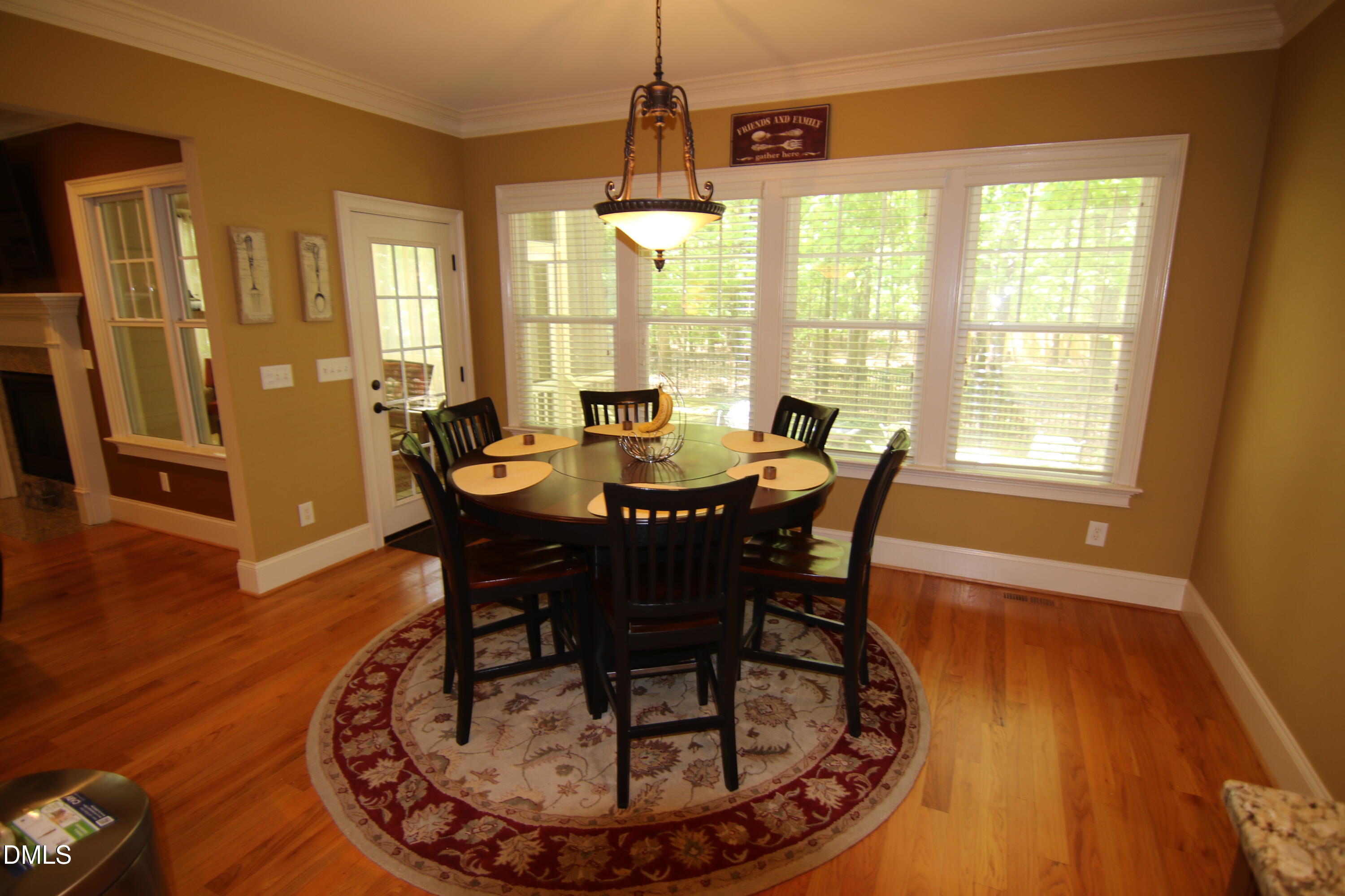 8104 Henderson Road Apex, NC 27539 - Photo 15 of 45 a dining room with furniture window wooden floor