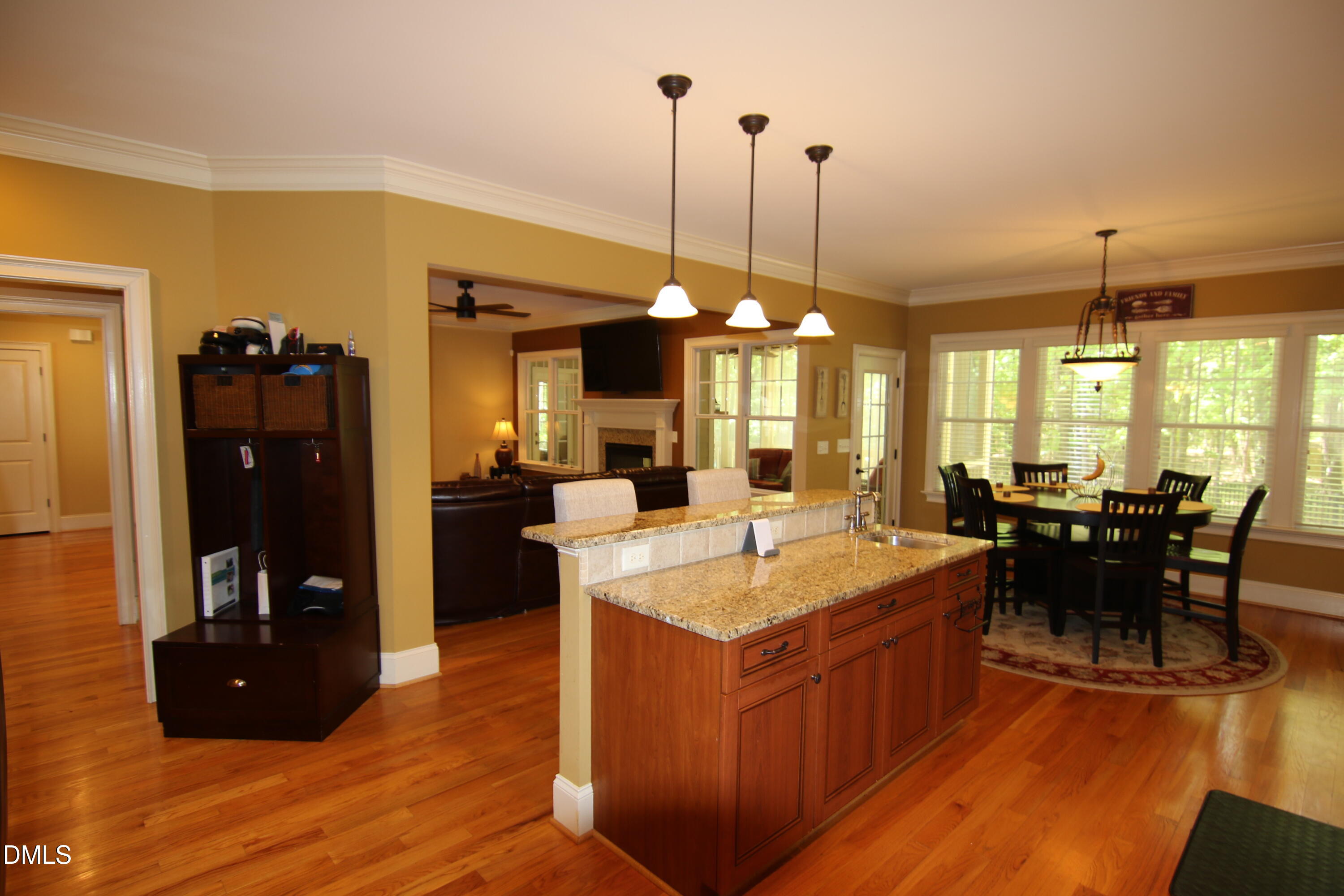8104 Henderson Road Apex, NC 27539 - Photo 17 of 45 a living room with furniture a dining table and chairs with wooden floor