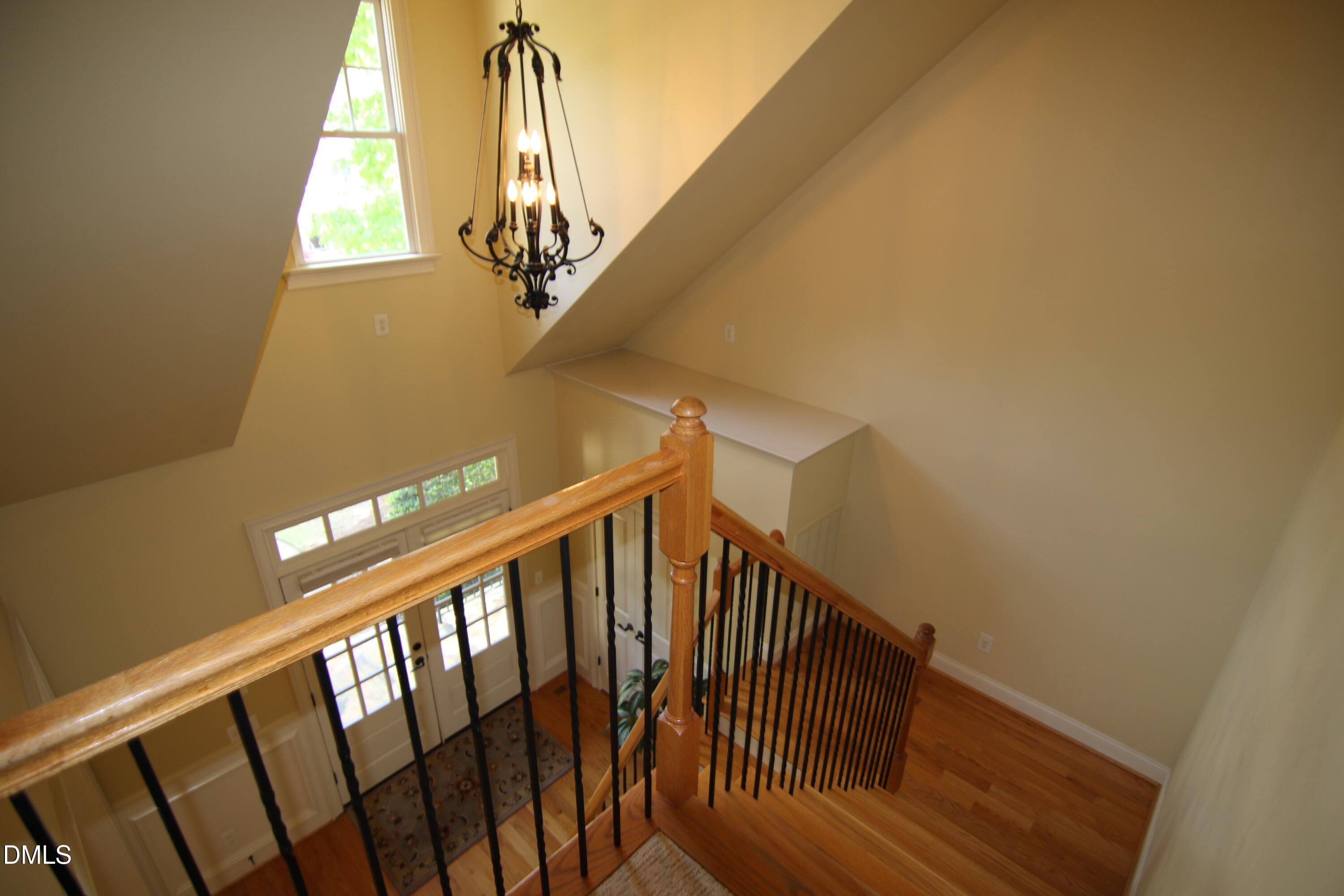 8104 Henderson Road Apex, NC 27539 - Photo 22 of 45 a view of staircase with railing and white walls