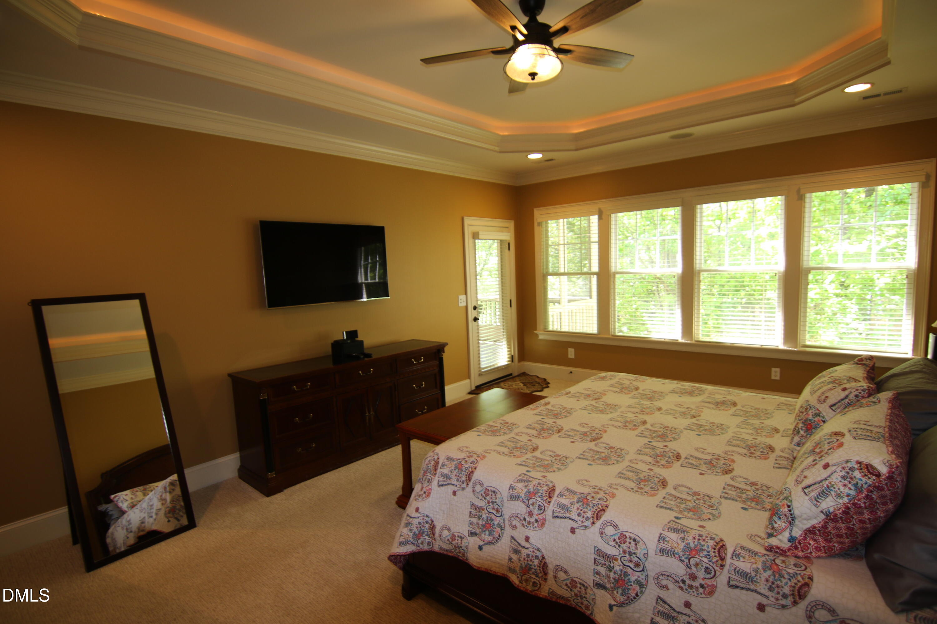 8104 Henderson Road Apex, NC 27539 - Photo 23 of 45 a bedroom with a bed and a flat screen tv