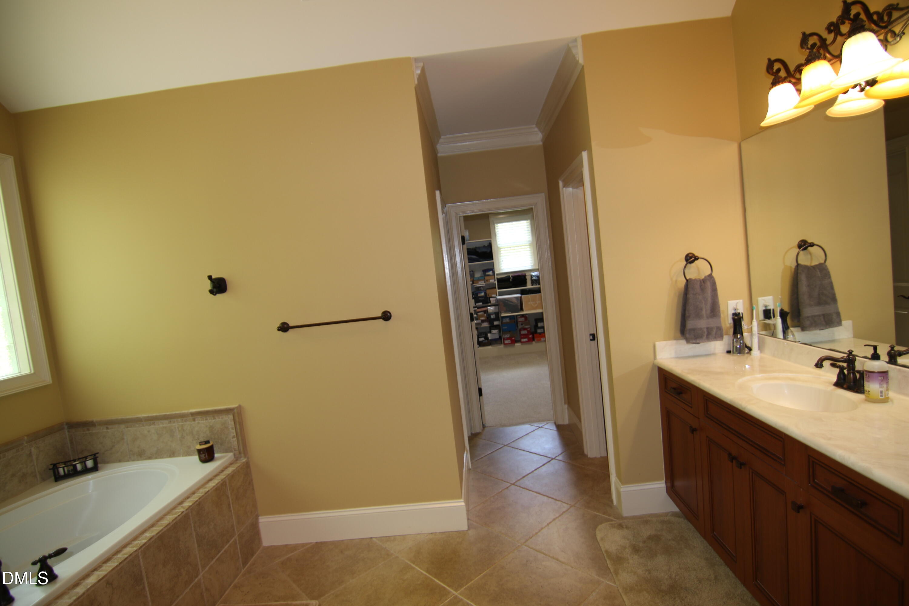 8104 Henderson Road Apex, NC 27539 - Photo 29 of 45 a bathroom with a tub sink and mirror