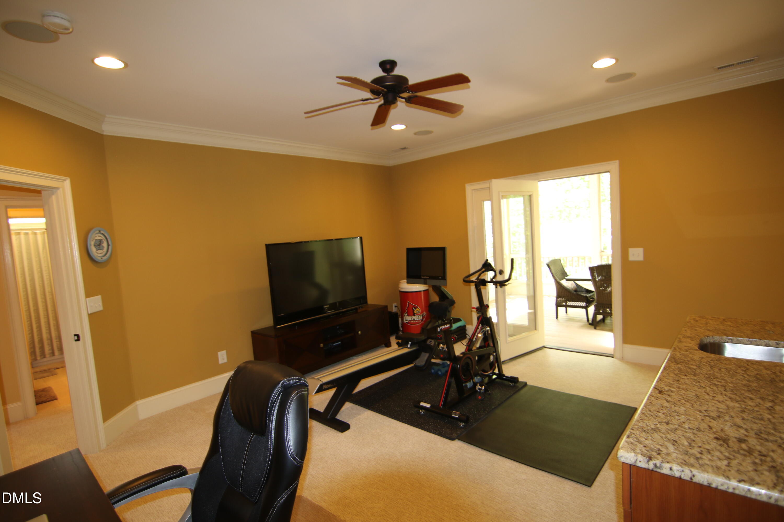 8104 Henderson Road Apex, NC 27539 - Photo 36 of 45 a living room with furniture and a flat screen tv