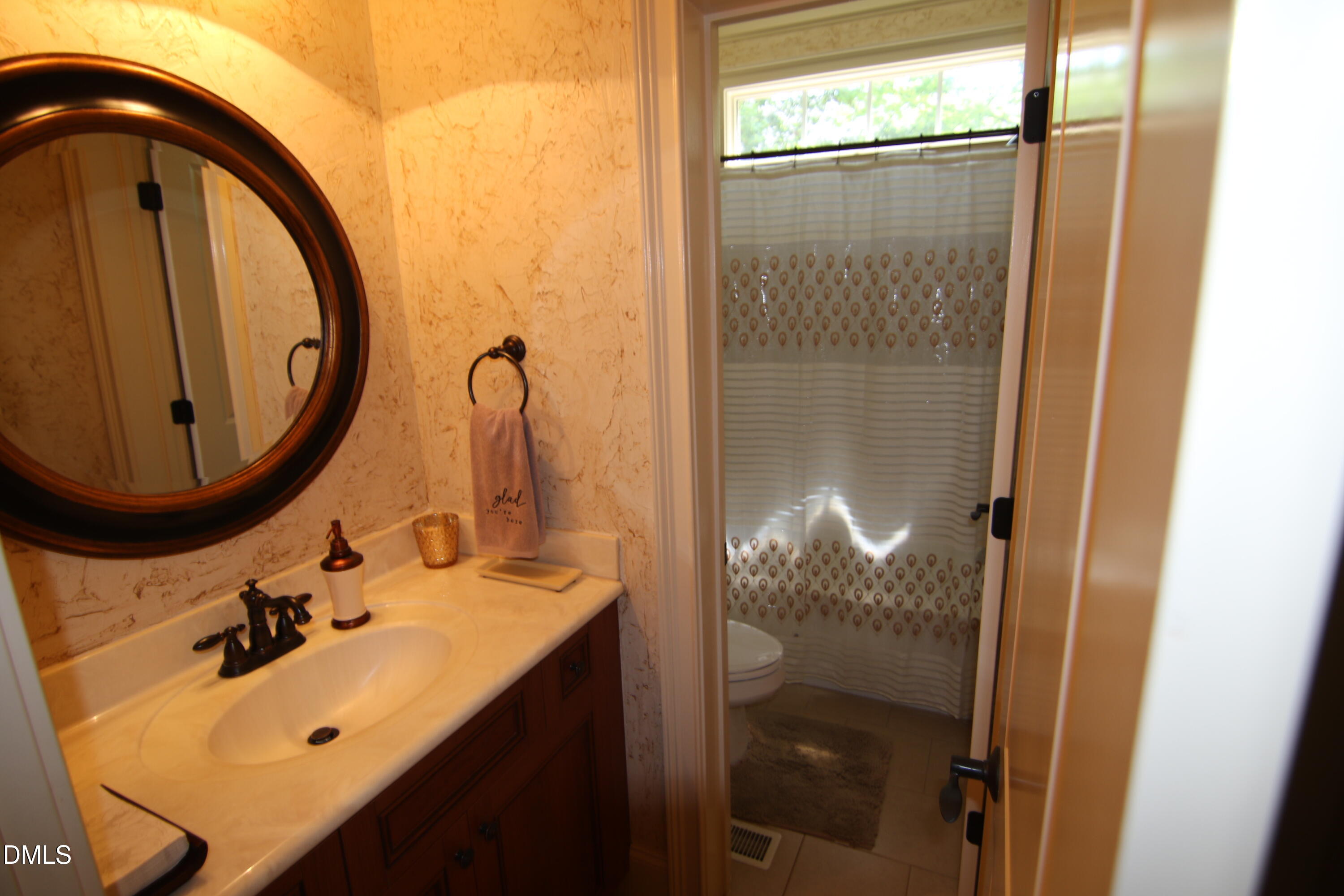 8104 Henderson Road Apex, NC 27539 - Photo 41 of 45 a bathroom with a sink mirror and vanity