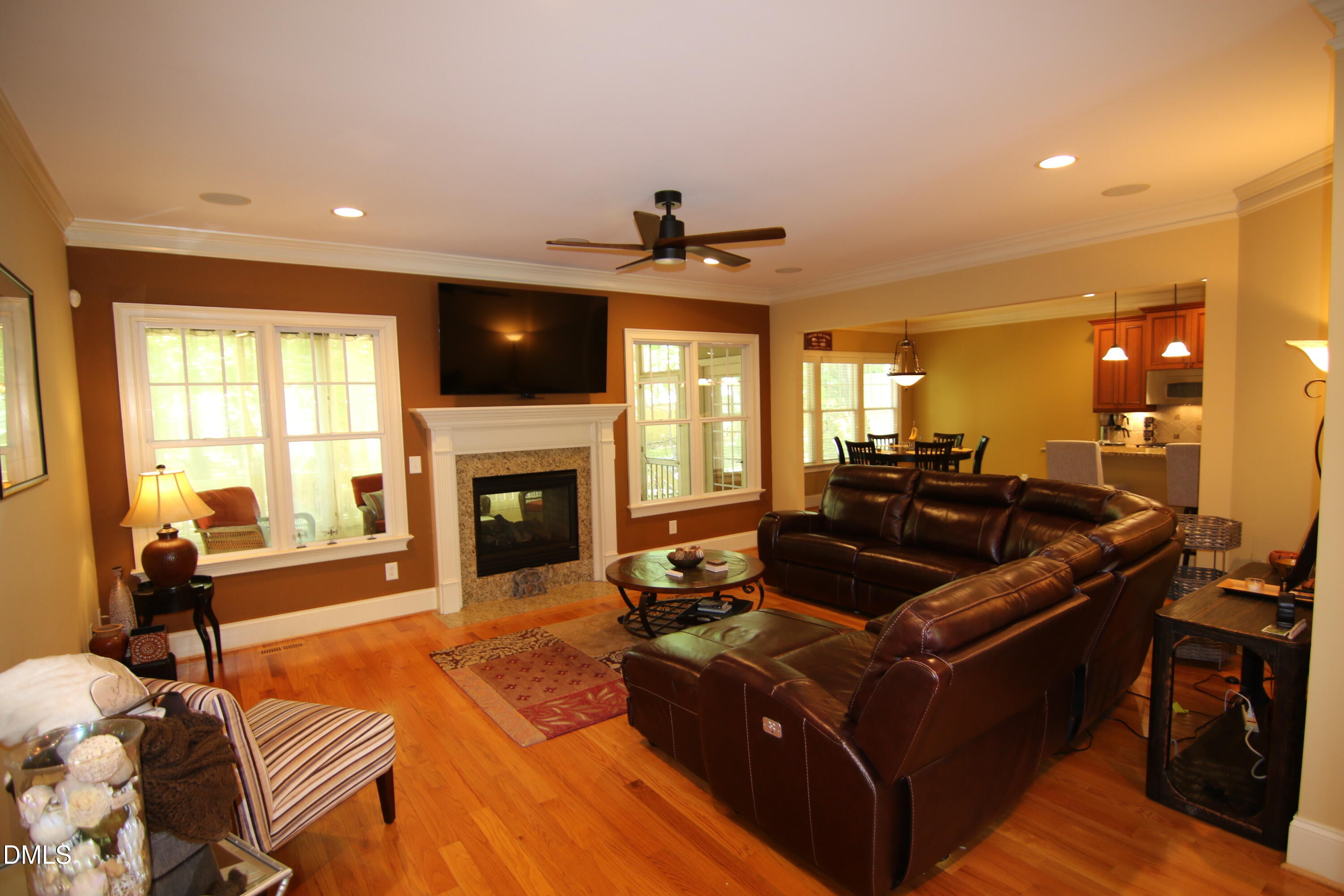 8104 Henderson Road Apex, NC 27539 - Photo 9 of 45 a living room with fireplace furniture and a flat screen tv