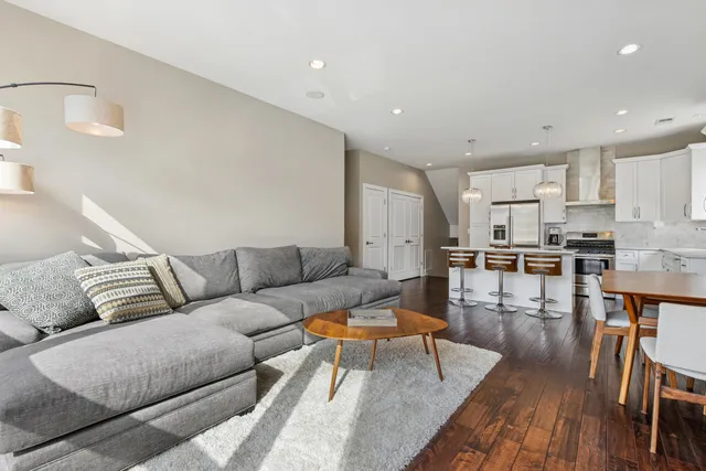 a living room with furniture and kitchen view