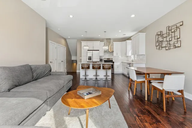 a living room with furniture and kitchen view