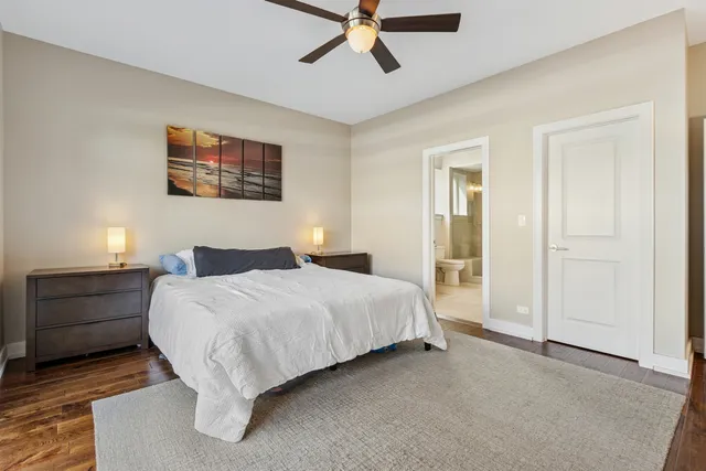 a spacious bedroom with a bed and a ceiling fan