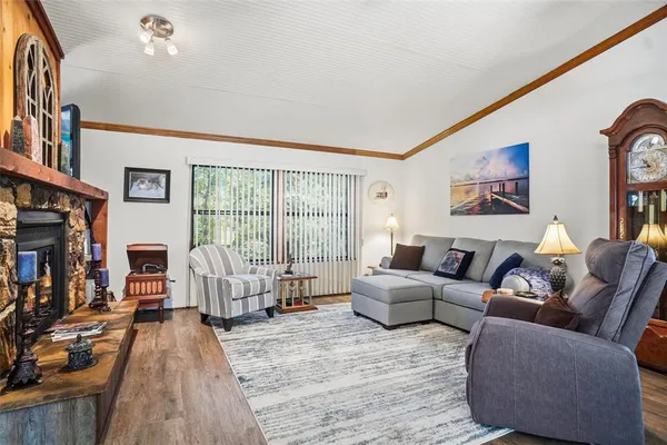 a living room with furniture a fireplace and a flat screen tv