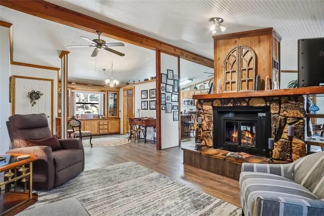 a living room with furniture a dining table and a wooden floor