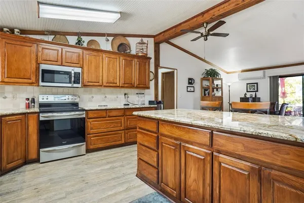 a kitchen with a sink cabinets and wooden floor
