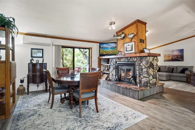 a view of a dining room with furniture a rug and wooden floor