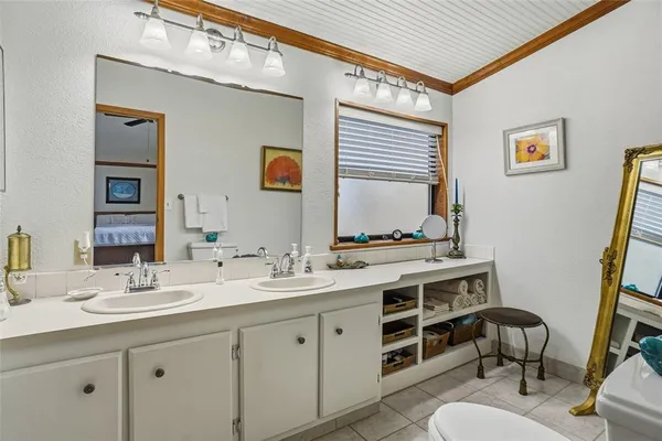 a bathroom with a shower sink vanity and mirror