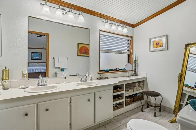 a bathroom with a shower sink vanity and mirror