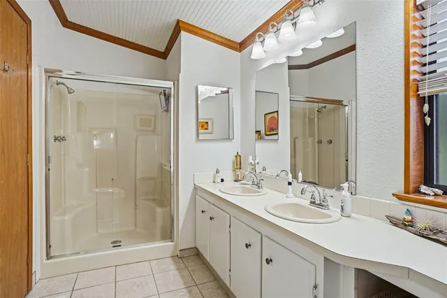 a bedroom with bed and a tv on dresser