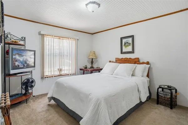 a kitchen with stainless steel appliances granite countertop white cabinets and a refrigerator