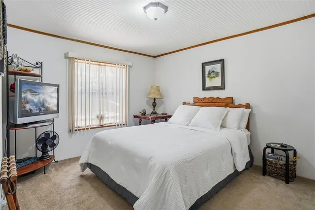 a kitchen with stainless steel appliances granite countertop white cabinets and a refrigerator