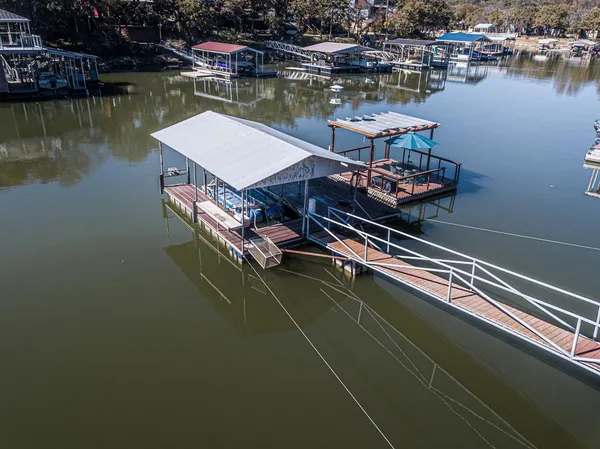 a view of an ocean with boats and trees in the background