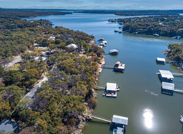 an aerial view of a house with a lake view