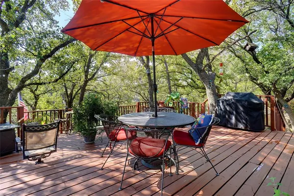 a view of a table and chairs under an umbrella in patio