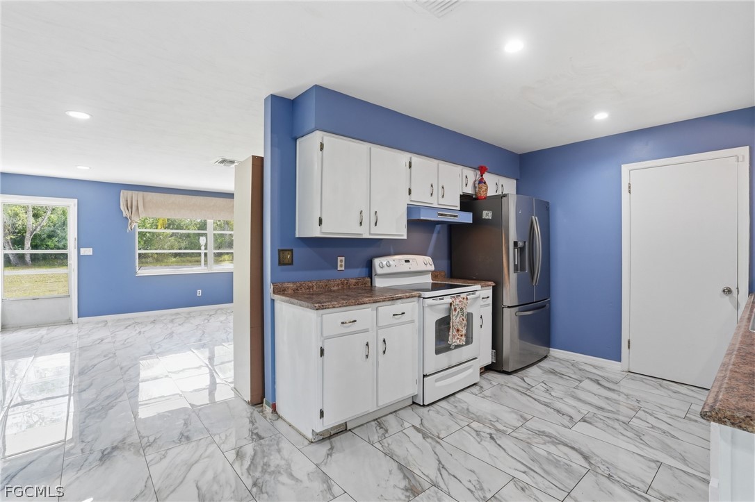 2180 Cook Lane Alva, FL 33920 - Photo 12 of 46 a kitchen with granite countertop a refrigerator sink and cabinets