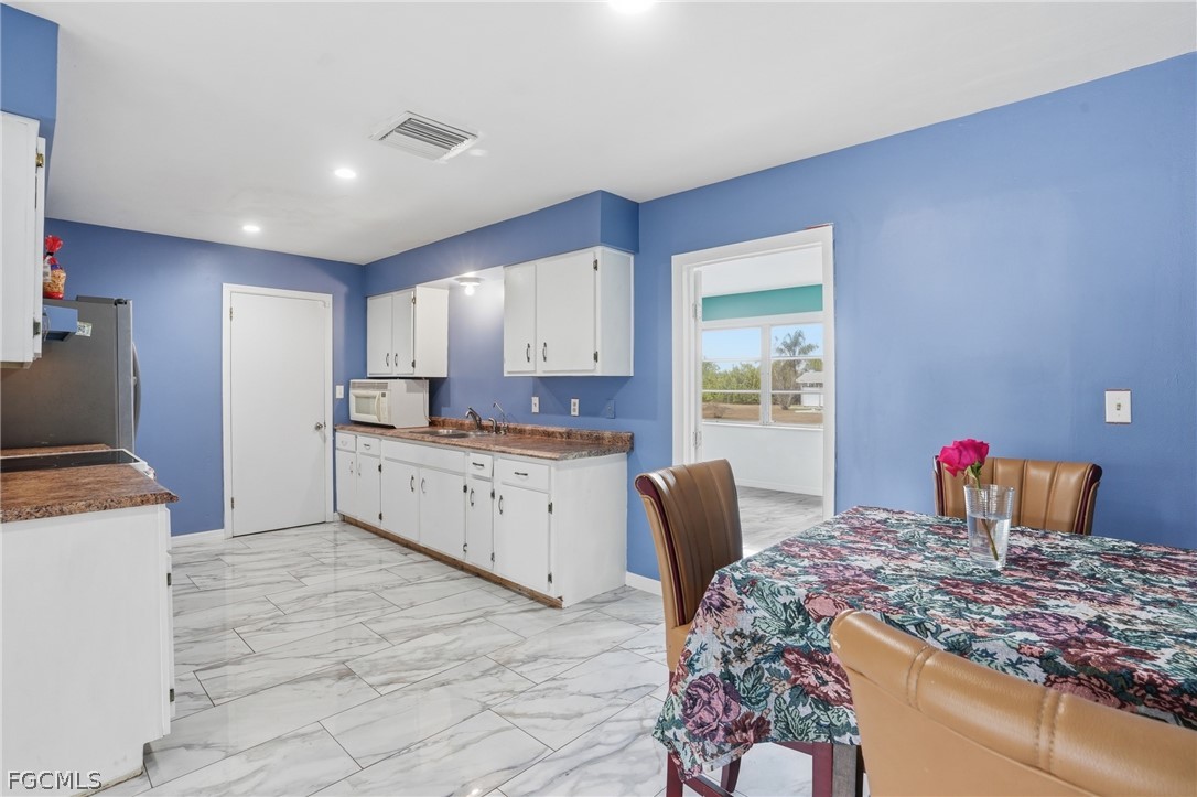 2180 Cook Lane Alva, FL 33920 - Photo 13 of 46 a kitchen with stainless steel appliances kitchen island granite countertop a sink and cabinets