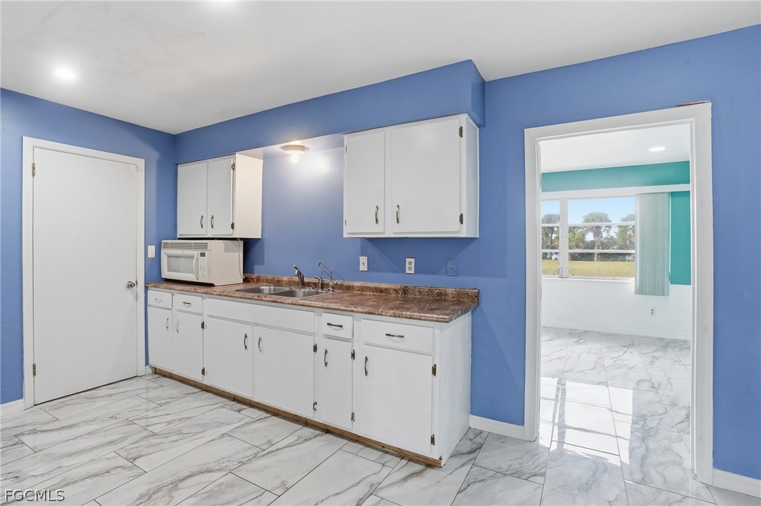 2180 Cook Lane Alva, FL 33920 - Photo 14 of 46 a kitchen with granite countertop a sink and cabinets