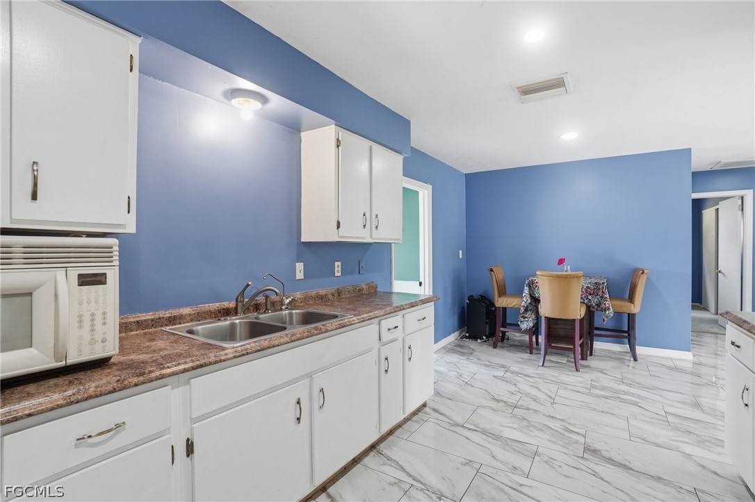 2180 Cook Lane Alva, FL 33920 - Photo 16 of 46 a kitchen with a sink and cabinets