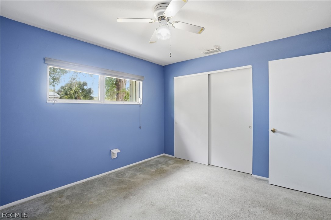 2180 Cook Lane Alva, FL 33920 - Photo 27 of 46 an empty room with windows and ceiling fan