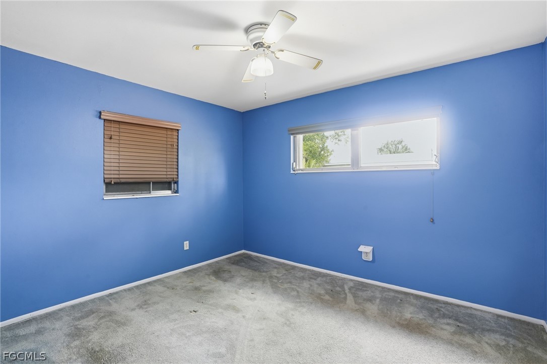 2180 Cook Lane Alva, FL 33920 - Photo 28 of 46 an empty room with windows and fan