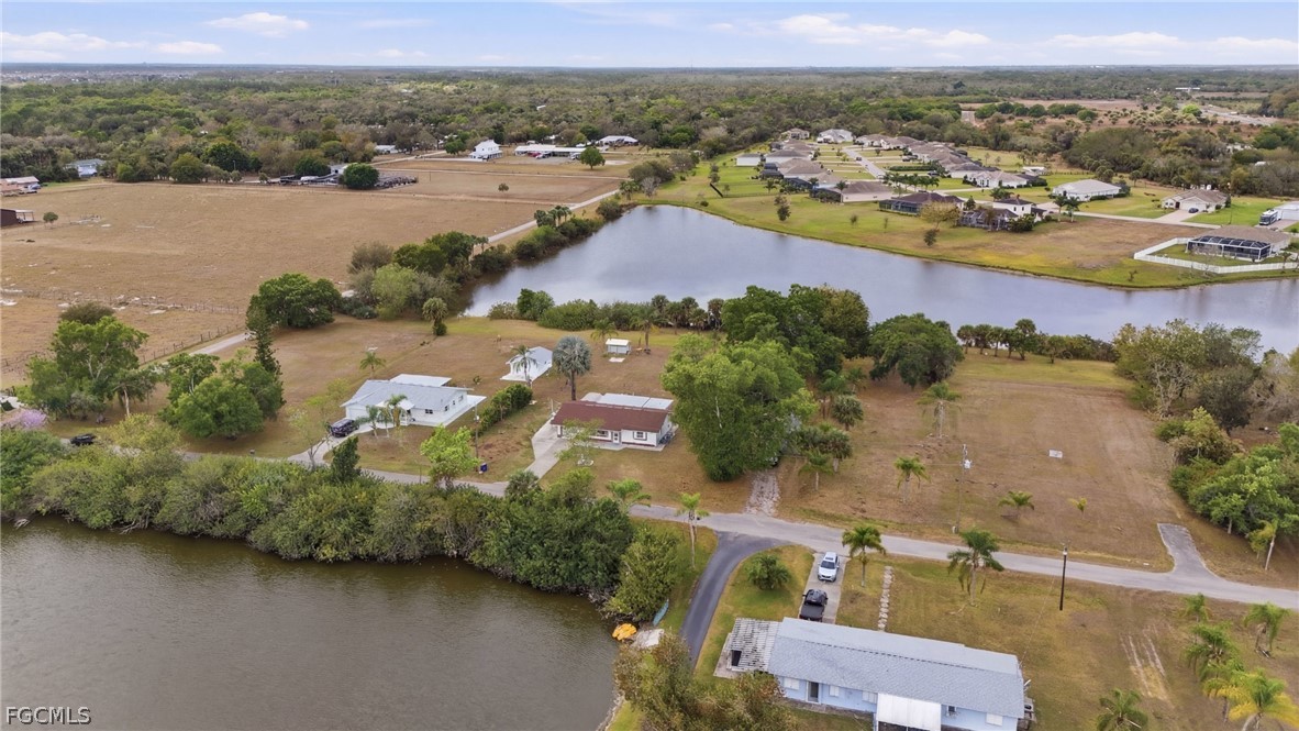 2180 Cook Lane Alva, FL 33920 - Photo 36 of 46 an aerial view of lake and residential houses with outdoor space