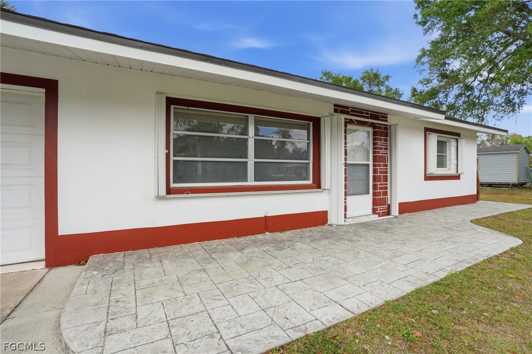 2180 Cook Lane Alva, FL 33920 - Photo 5 of 46 a front view of a house with a yard