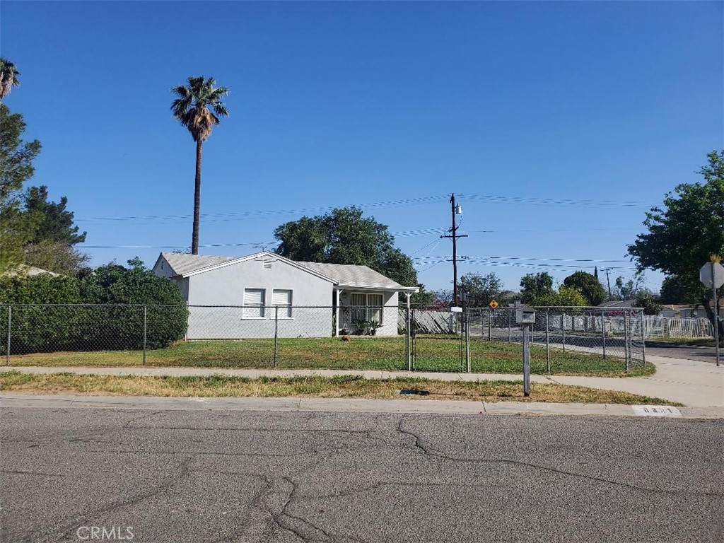 a view of a house with a yard and a palm tree