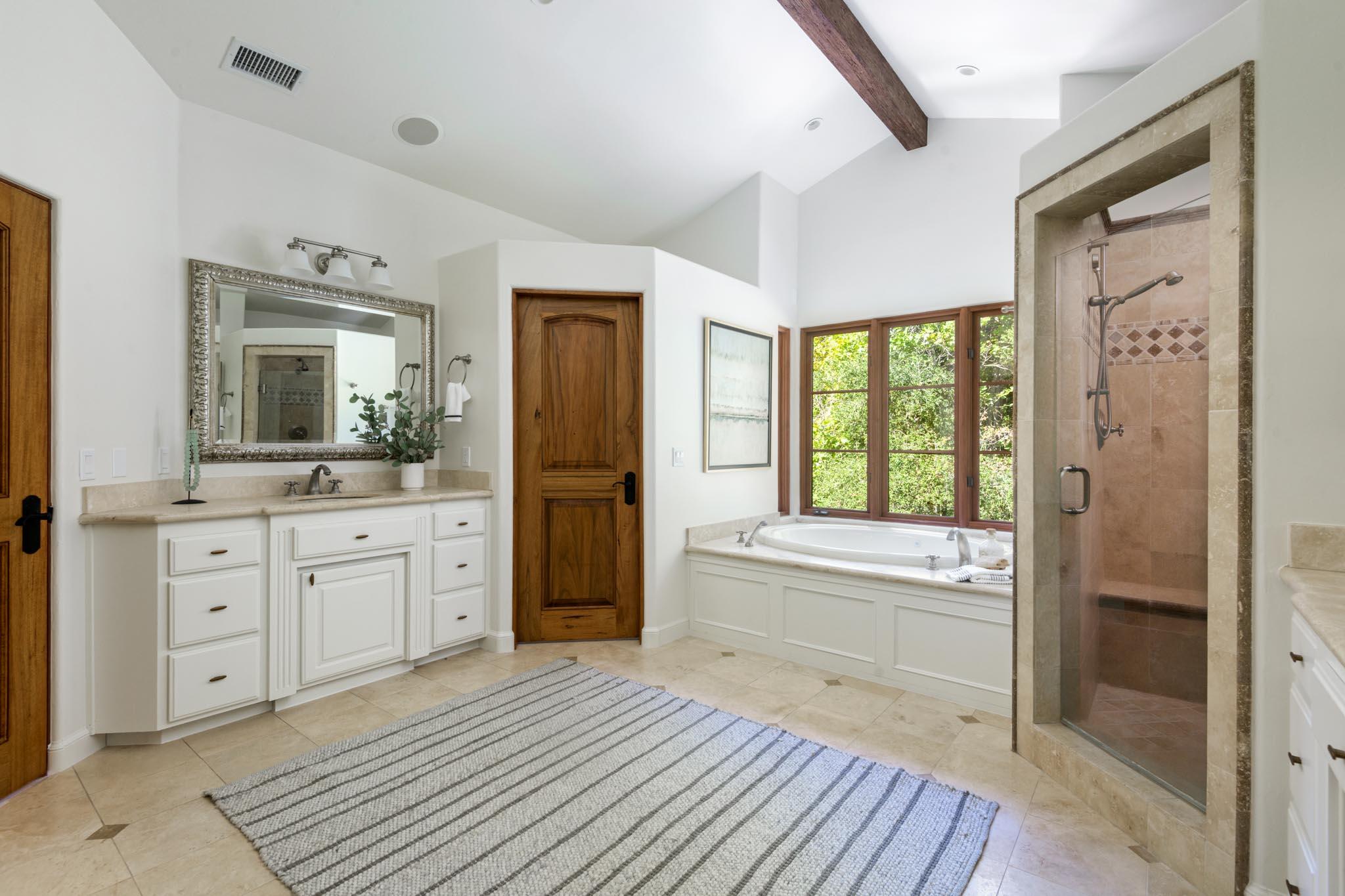 2030 Creekside Road Santa Barbara, CA 93108 - Photo 22 of 41 a spacious bathroom with a granite countertop sink mirror and a bathtub