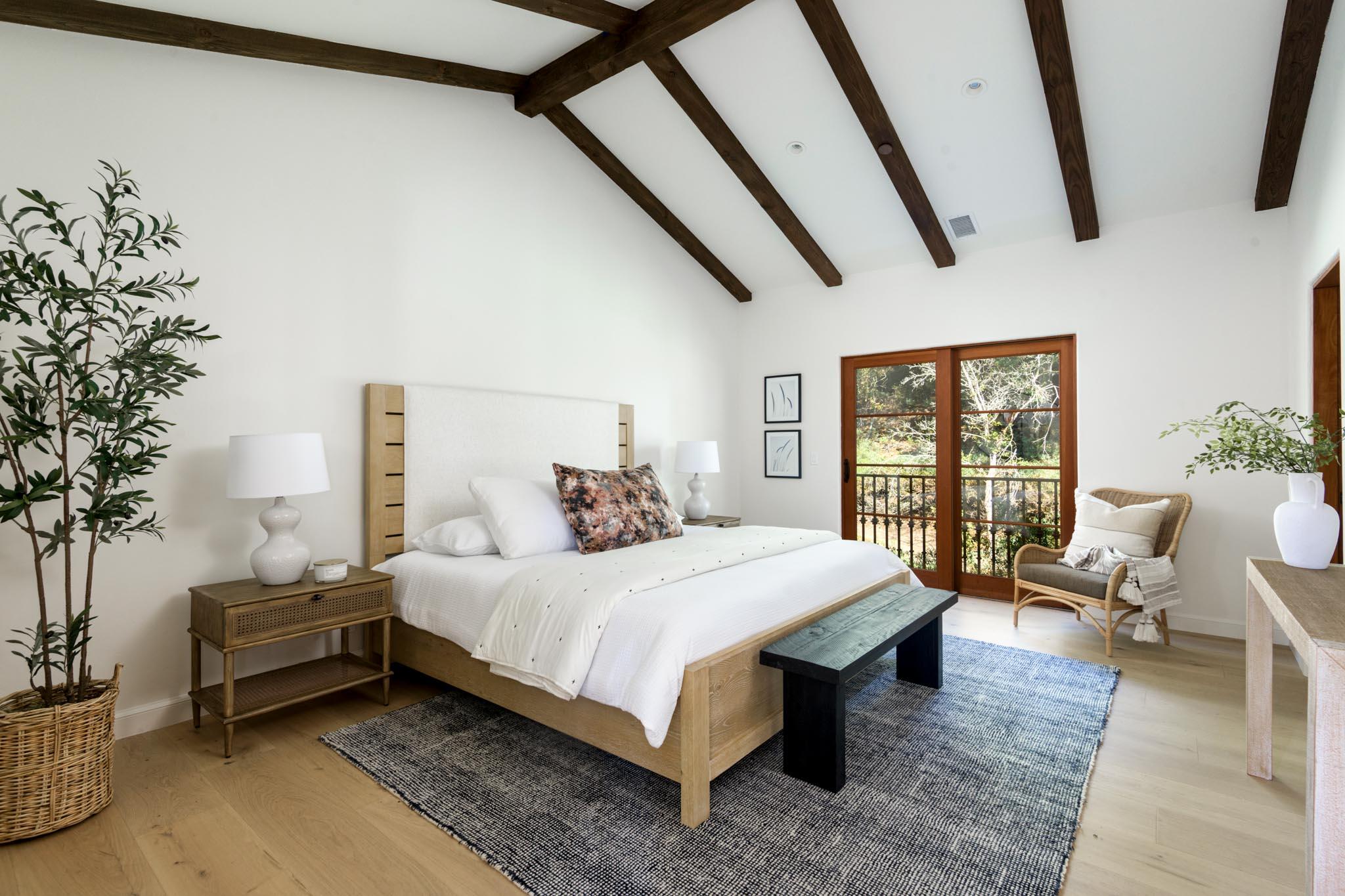 2030 Creekside Road Santa Barbara, CA 93108 - Photo 23 of 41 a bedroom with a bed a table and chair with the potted plants