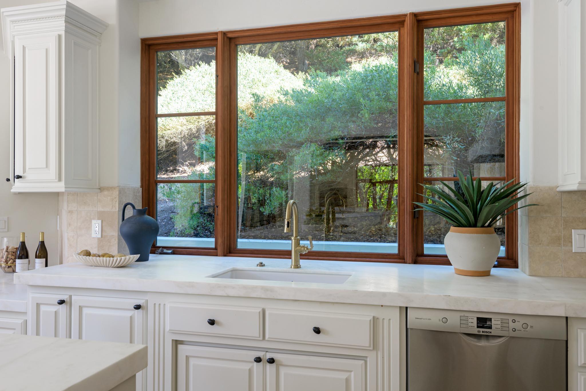 2030 Creekside Road Santa Barbara, CA 93108 - Photo 8 of 41 a kitchen with a window a sink and cabinets